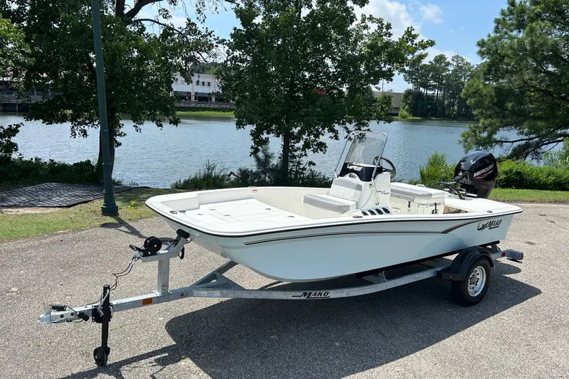 The Image of 2026 Mako Pro Skiff 15 CC boat on trailer by a lake. - 0