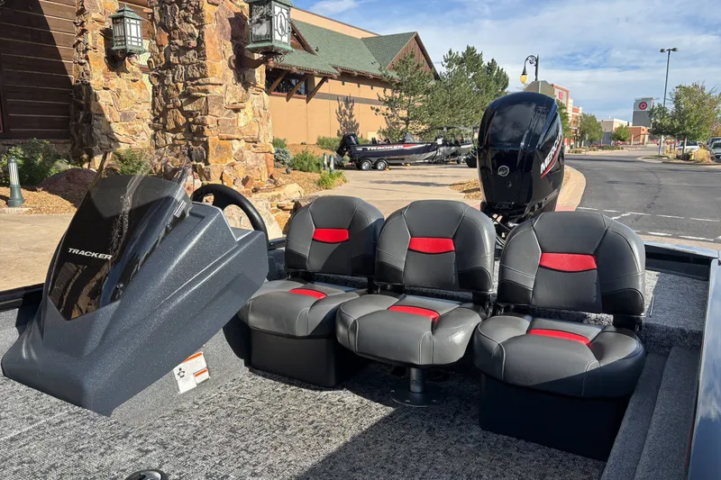 Slide: The Image of 2026 Tracker Pro Team 175 Crappie Edition boat with seating and console, parked outdoors. - 17