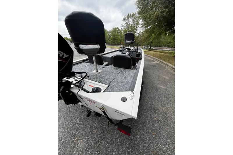 Slide: The Image of 2026 Tracker Pro 170 boat with seating and motor, parked on a road. - 4