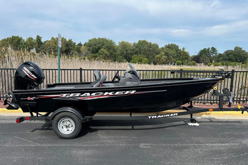 The Image of 2026 Tracker Super Guide V-16 SC boat on trailer, parked outdoors. - 0