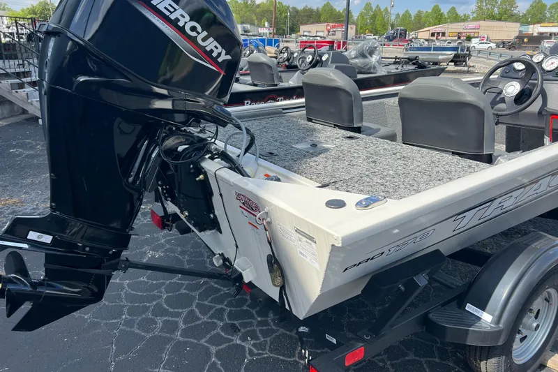 Slide: The Image of 2026 Tracker Pro 170 boat with Mercury outboard motor, parked on a trailer. - 10