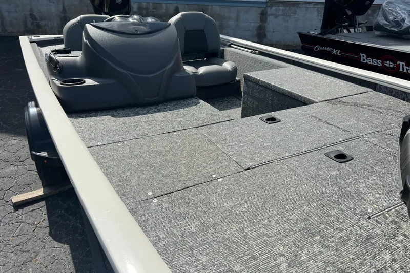 Slide: The Image of 2026 Tracker Pro 170 boat interior with gray seating and carpeted deck. - 9