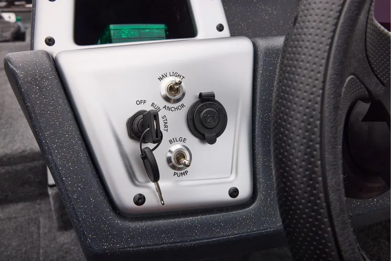 Slide: The Image of 2026 Tracker Pro Team 190 boat dashboard with ignition, switches, and 12V outlet. - 28