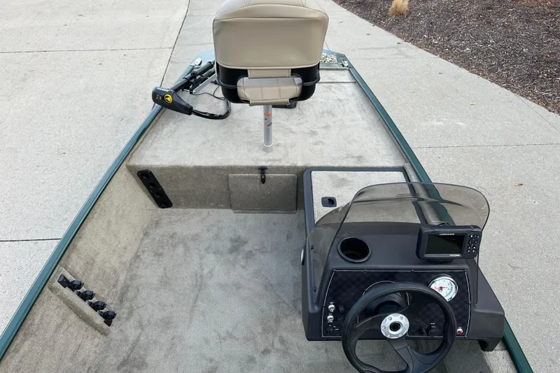 Slide: The Image of 2026 Tracker Bass Tracker Classic Limited boat interior with steering console and seating. - 4