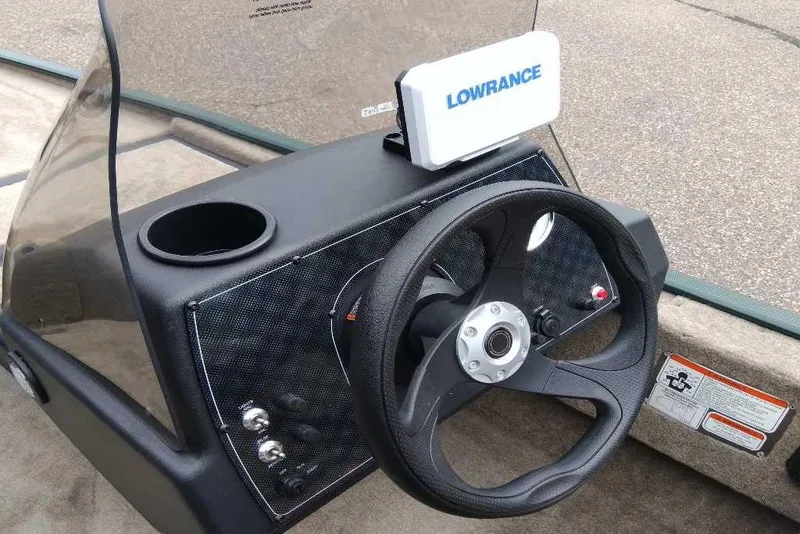 Slide: The Image of 2026 Tracker Bass Tracker Classic Limited boat dashboard with Lowrance device and steering wheel. - 5