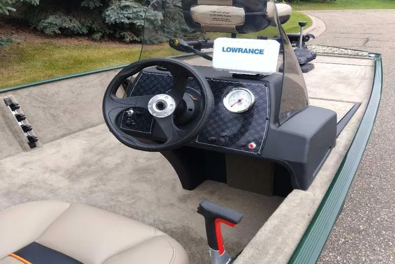 Slide: The Image of 2026 Tracker Bass Tracker Classic Limited boat interior with steering wheel and Lowrance device. - 6