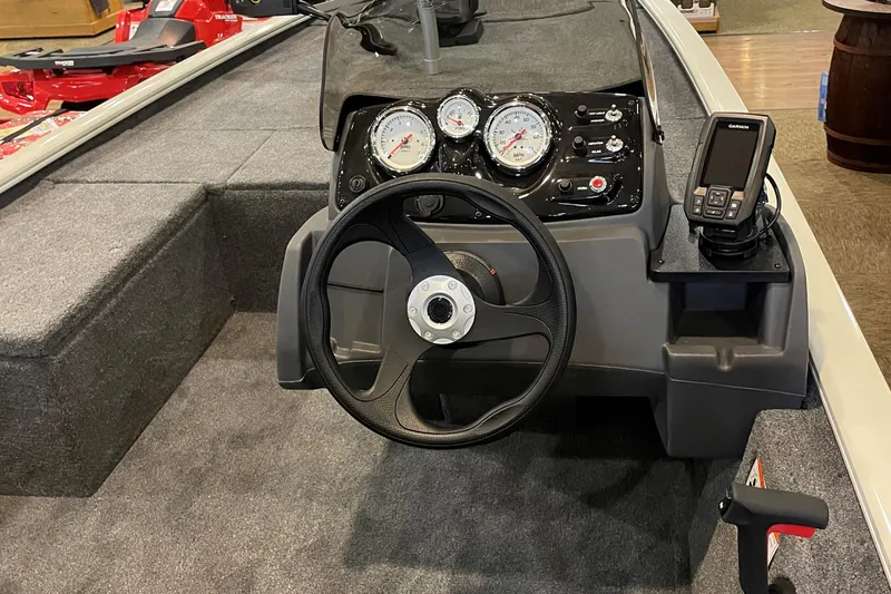 Slide: The Image of 2026 Tracker Pro 170 boat dashboard with steering wheel and gauges. - 2
