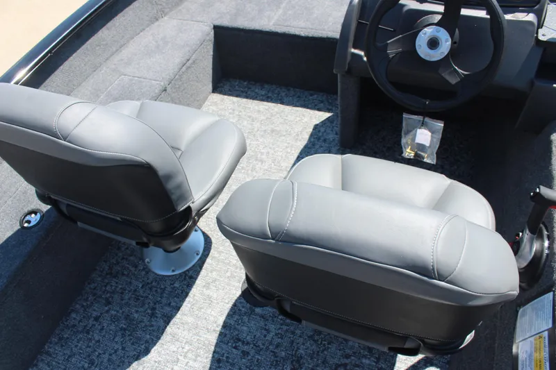 Slide: The Image of 2026 Tracker Super Guide V-16 SC boat interior with gray seats and steering wheel. - 10