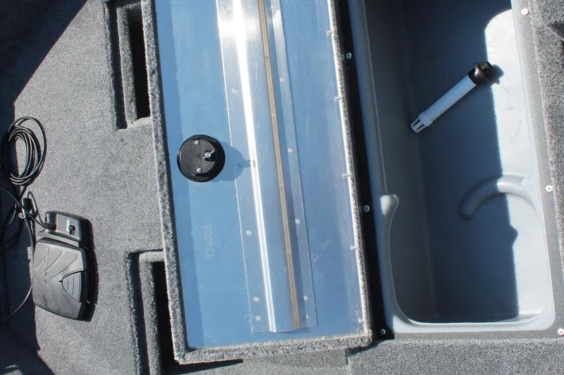 Slide: The Image of Interior of 2026 Tracker Super Guide V-16 SC boat showing storage compartments and equipment. - 13