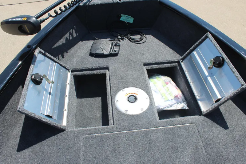 Slide: The Image of 2026 Tracker Super Guide V-16 SC boat interior with storage compartments and fishing gear. - 14