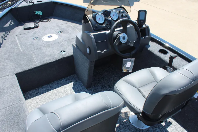 Slide: The Image of 2026 Tracker Super Guide V-16 SC boat interior with steering wheel and seating. - 17