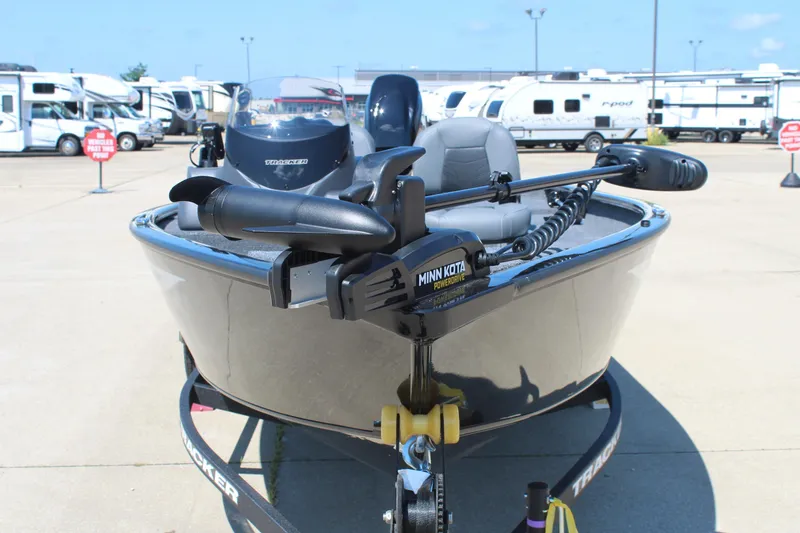 Slide: The Image of 2026 Tracker Super Guide V-16 SC boat with Minn Kota motor in parking lot. - 2