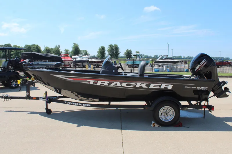Slide: The Image of 2026 Tracker Super Guide V-16 SC boat on trailer, parked outdoors. - 4