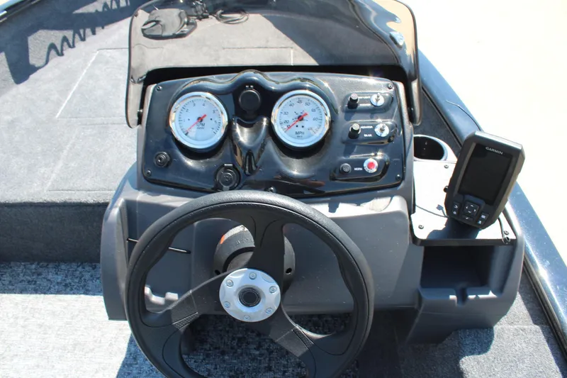Slide: The Image of 2026 Tracker Super Guide V-16 SC boat dashboard with steering wheel and Garmin device. - 9