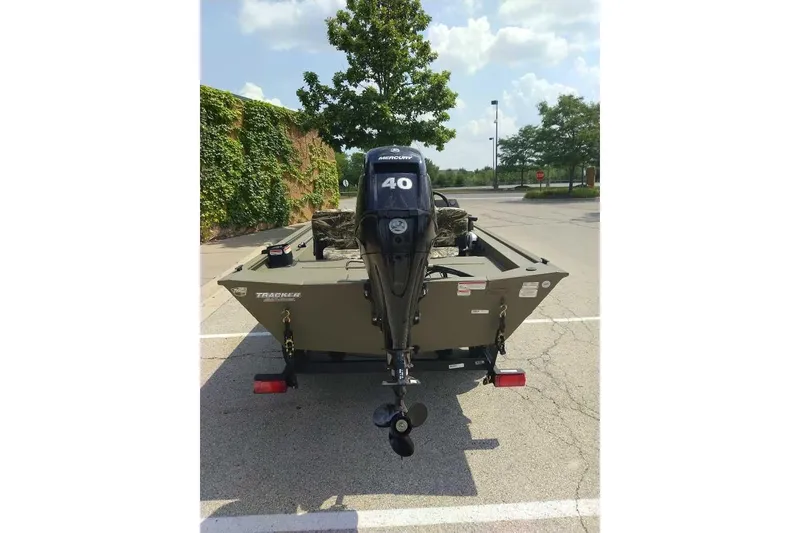 Slide: The Image of 2026 Tracker Grizzly 1754 SC boat with 40 HP motor in parking lot. - 3