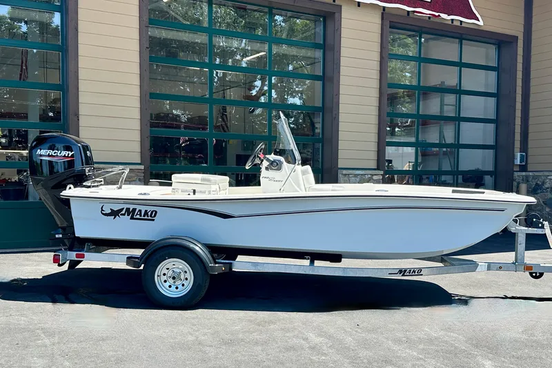 The Image of 2026 Mako Pro Skiff 15 CC boat on trailer, parked outside a building. - 0