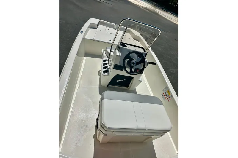 Slide: The Image of 2026 Mako Pro Skiff 15 CC boat interior with steering console and seating. - 57
