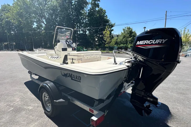 Slide: The Image of 2026 Mako Pro Skiff 15 CC boat with Mercury outboard motor on trailer. - 58