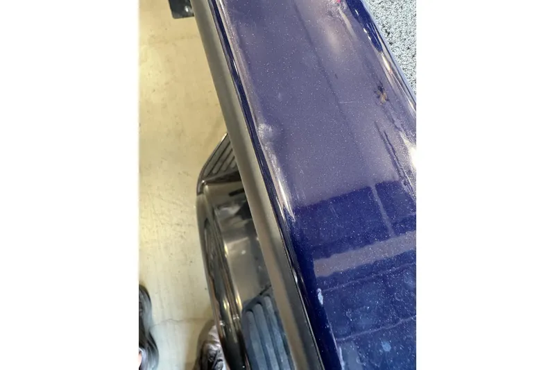 Slide: The Image of Close-up of 2026 Tracker Super Guide V-16 SC boat's glossy blue surface. - 51