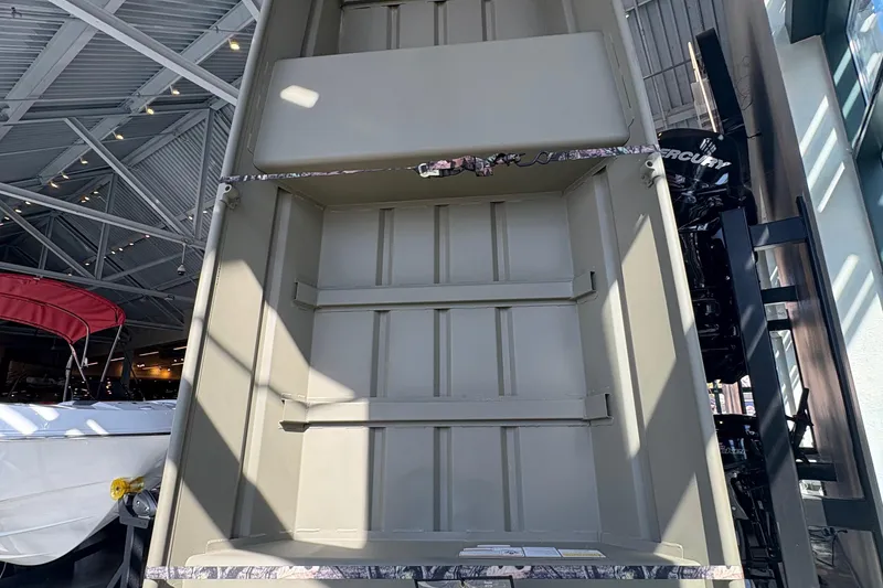 The Image of 2026 Tracker Grizzly 14 Jon boat interior view in showroom setting. - 0