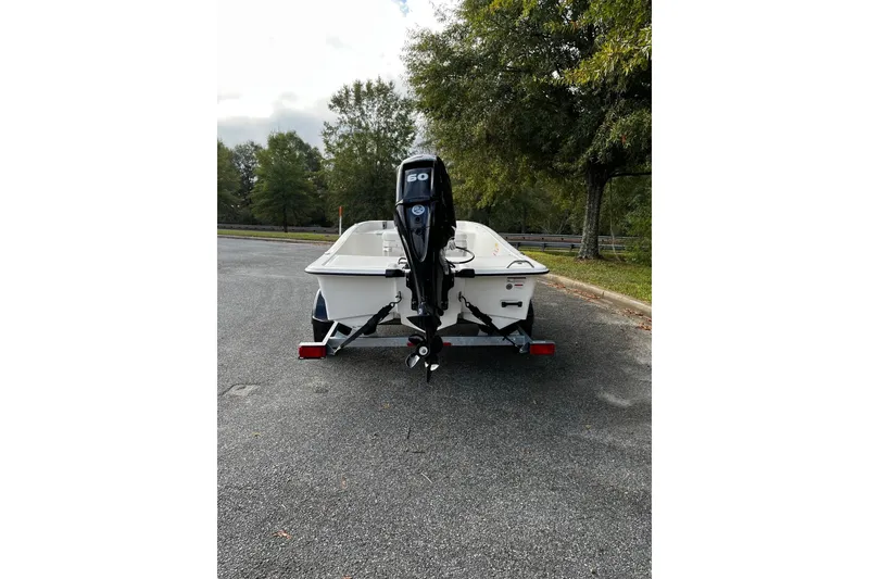 Slide: The Image of 2026 Mako Pro Skiff 15 CC boat on trailer, parked outdoors. - 4