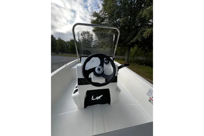 Slide: The Image of 2026 Mako Pro Skiff 15 CC boat console with steering wheel and windshield. - 6
