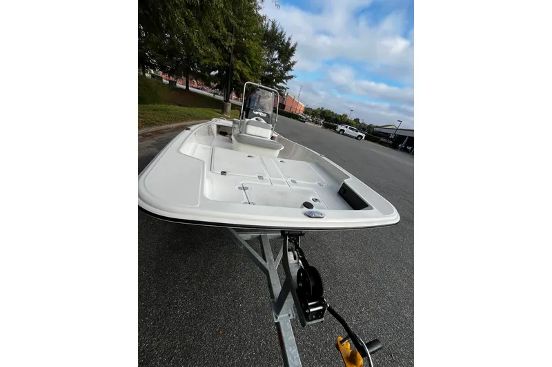 Slide: The Image of 2026 Mako Pro Skiff 15 CC boat on trailer, parked outdoors. - 7
