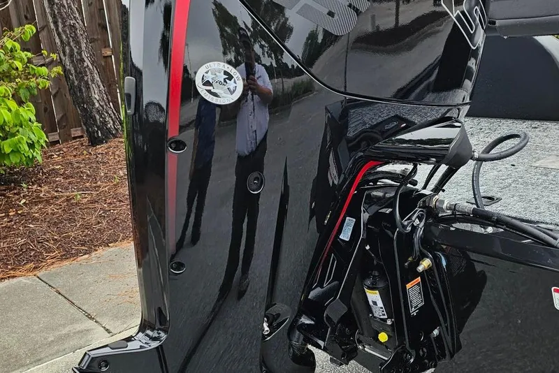 Slide: The Image of 2026 Tracker Pro Team 190 boat engine, black with red accents, parked outdoors. - 4