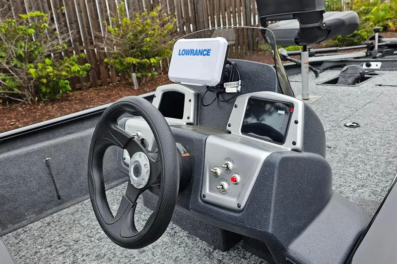 Slide: The Image of 2026 Tracker Pro Team 190 boat dashboard with steering wheel and Lowrance display. - 5