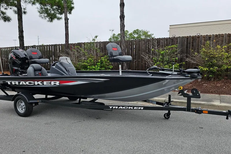 Slide: The Image of 2026 Tracker Pro Team 190 boat on trailer, parked outdoors. - 6