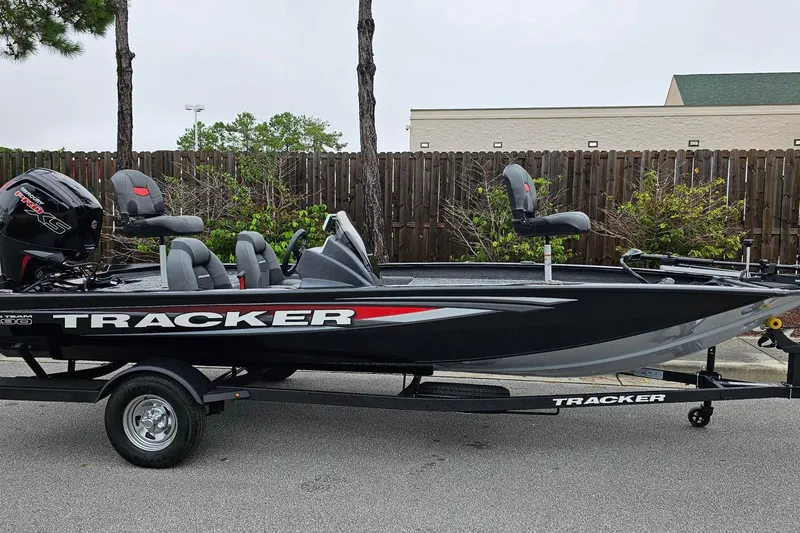 Slide: The Image of 2026 Tracker Pro Team 190 boat on trailer, parked outdoors. - 7