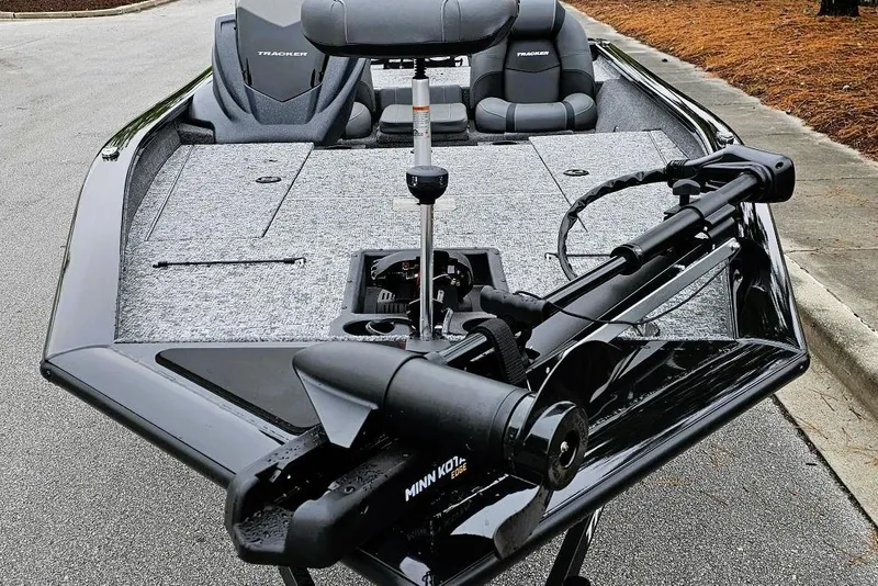 Slide: The Image of 2026 Tracker Pro Team 190 boat with Minn Kota trolling motor on a paved surface. - 8