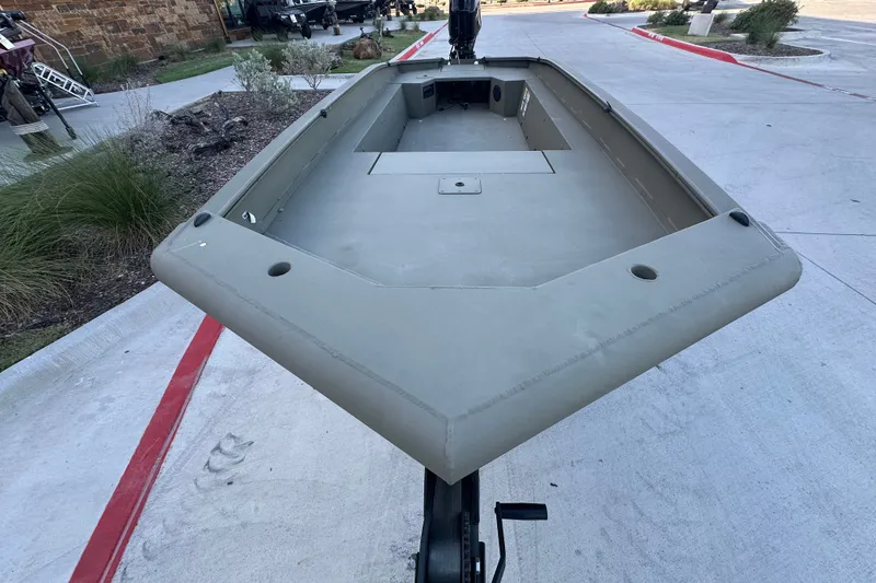 Slide: The Image of 2026 Tracker Grizzly 1650 T Prairie Wings Edition boat on display outdoors. - 22