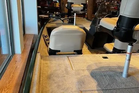 Slide: The Image of 2026 Tracker Bass Tracker Classic Limited interior with beige seating and carpeted flooring. - 2