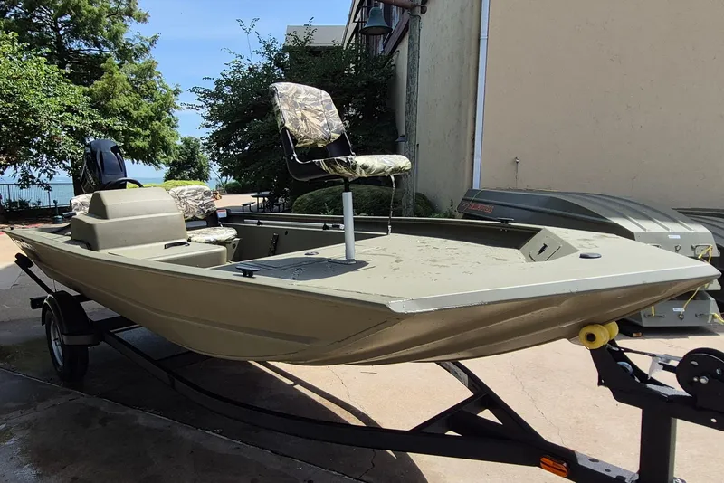 Slide: The Image of 2026 Tracker Grizzly 1754 SC boat on trailer, featuring camouflage seating and spacious deck. - 3