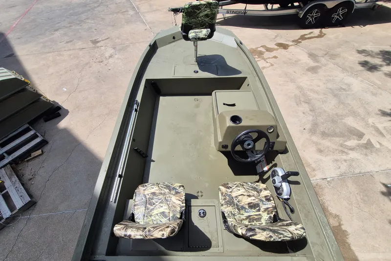 Slide: The Image of 2026 Tracker Grizzly 1754 SC boat with camo seats and steering console. - 8