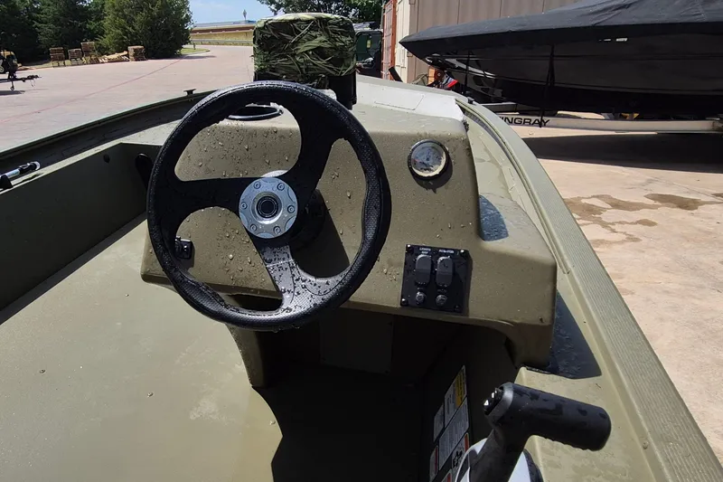 Slide: The Image of Steering console of 2026 Tracker Grizzly 1754 SC boat, featuring controls and gauges. - 7