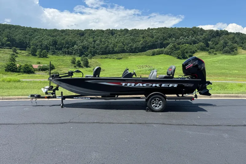 Slide: The Image of 2026 Tracker Pro Team 190 boat on trailer, parked with scenic green hills in background. - 0