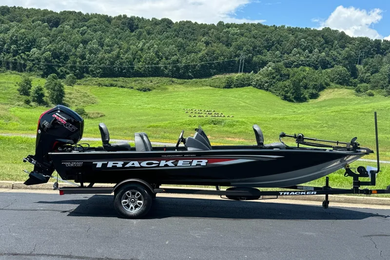 Slide: The Image of 2026 Tracker Pro Team 190 boat on trailer, parked with scenic green hills in background. - 3