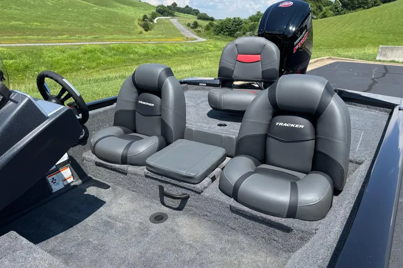 Slide: The Image of 2026 Tracker Pro Team 190 boat interior with gray seating and steering wheel. - 7