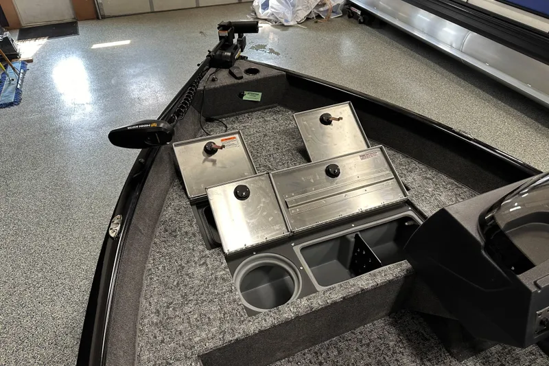 Slide: The Image of 2026 Tracker Pro Guide V-16 SC boat interior with storage compartments and trolling motor. - 12