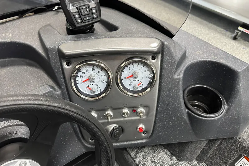 Slide: The Image of Dashboard of 2026 Tracker Pro Guide V-16 SC boat with gauges and controls. - 17