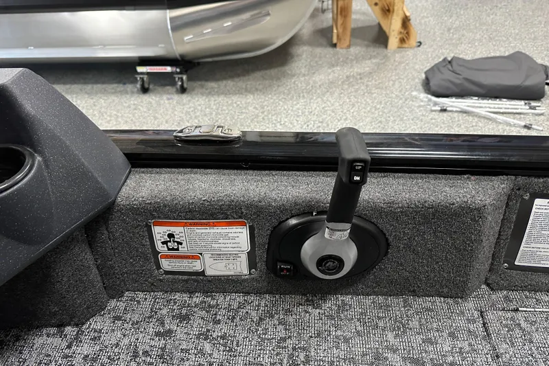 Slide: The Image of 2026 Tracker Pro Guide V-16 SC boat control panel with throttle lever and warning labels. - 20