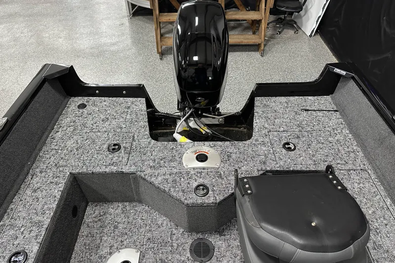 Slide: The Image of 2026 Tracker Pro Guide V-16 SC boat interior with motor and seating. - 21