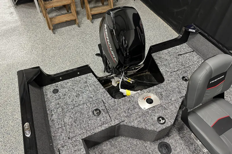 Slide: The Image of 2026 Tracker Pro Guide V-16 SC boat interior with Mercury engine and seating. - 22
