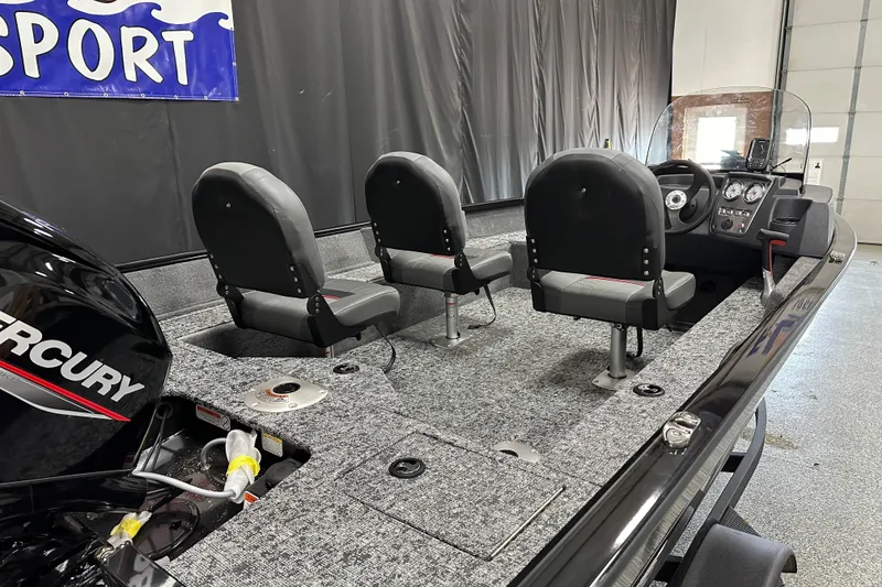 Slide: The Image of 2026 Tracker Pro Guide V-16 SC boat interior with three seats and Mercury engine. - 3