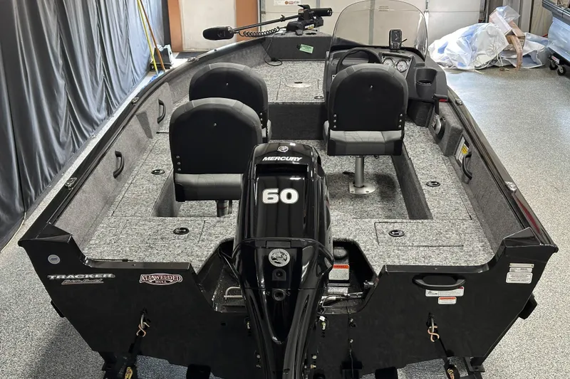 Slide: The Image of 2026 Tracker Pro Guide V-16 SC boat with Mercury 60 engine in a garage. - 6