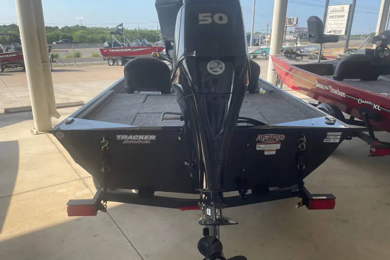 Slide: The Image of 2026 Tracker Bass Tracker Classic XL boat with 50 HP engine displayed at dealership. - 2