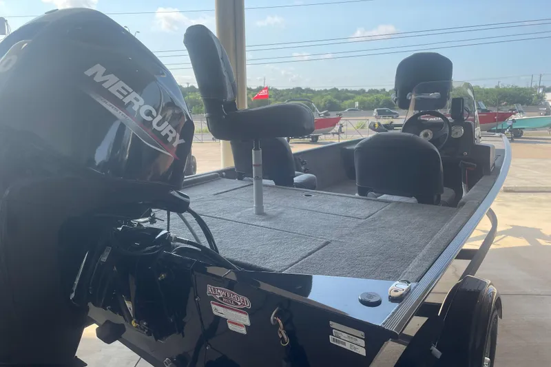 Slide: The Image of 2026 Tracker Bass Tracker Classic XL boat with Mercury engine, parked outdoors. - 3