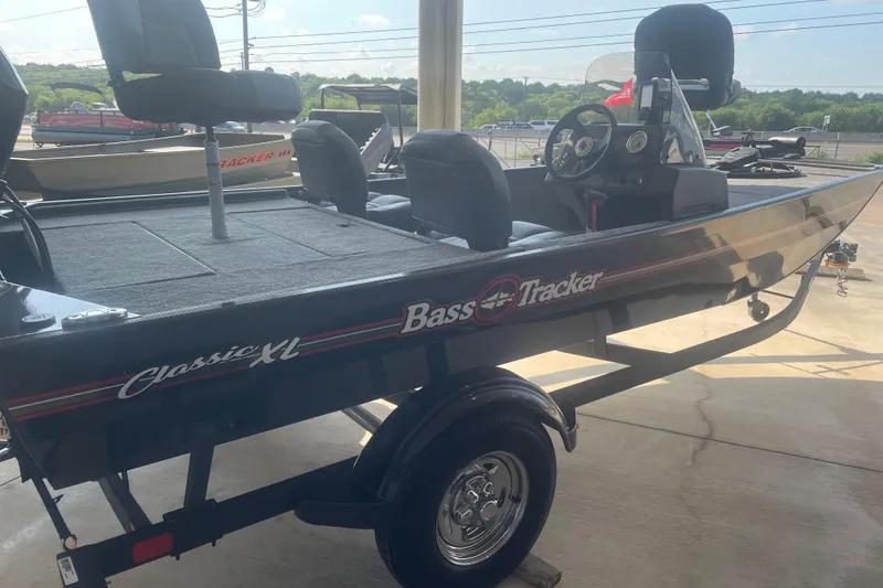 Slide: The Image of 2026 Tracker Bass Tracker Classic XL boat on trailer, side view in outdoor setting. - 4